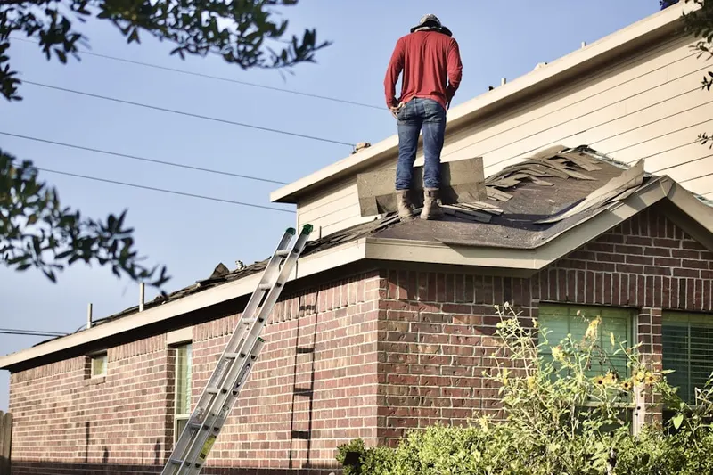 Professional roofer working on a residential roof in Stonewall Manor